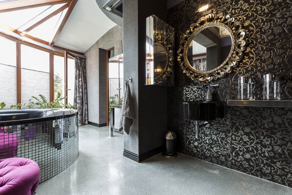 Very luxurious futuristic dark bathroom with mosaic tilted bathtub with balcony and partially glass roof